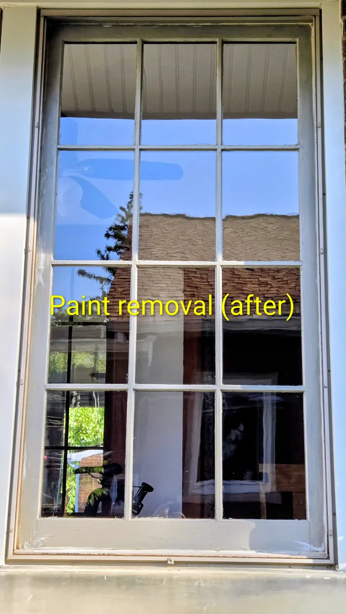 Same window pane with every paint fleck gone after careful blade-and-solution treatment