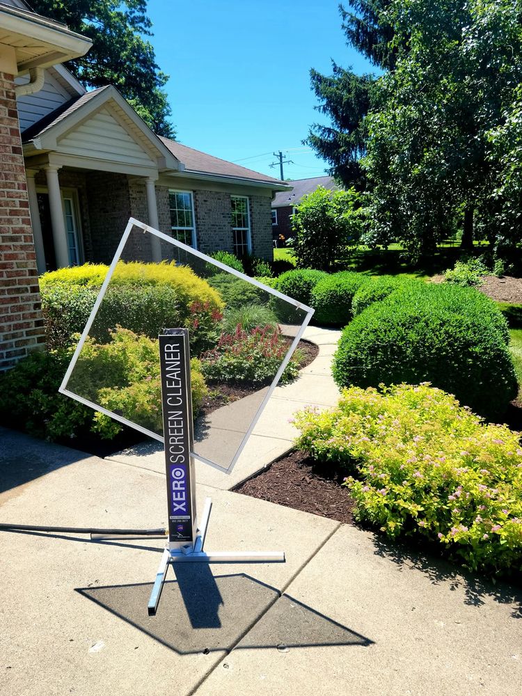 Xero professional screen cleaner rig set up in a yard before removing grime from window screens