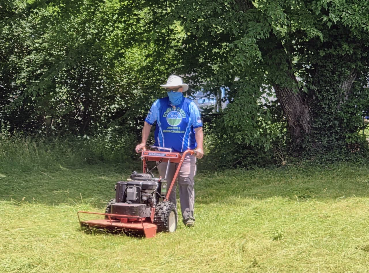 Tim Harrison in Down to Earth gear mowing tall, overgrown grass with a DR all-terrain brush mower in Clermont County, Ohio