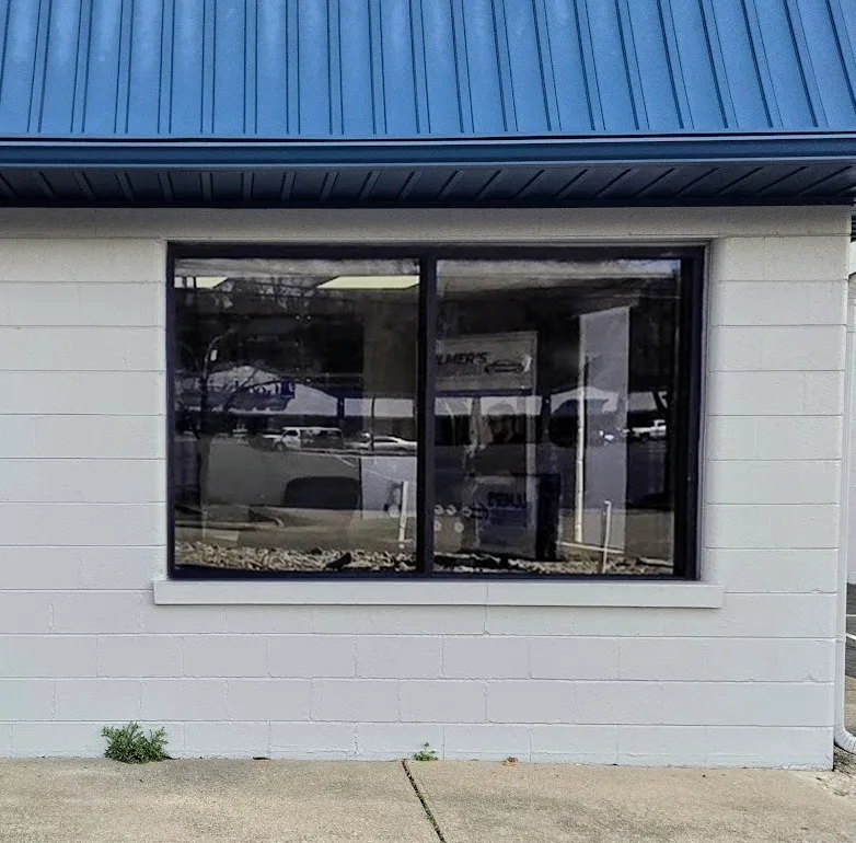 Same storefront with vinyl lettering fully removed — glass clean and clear