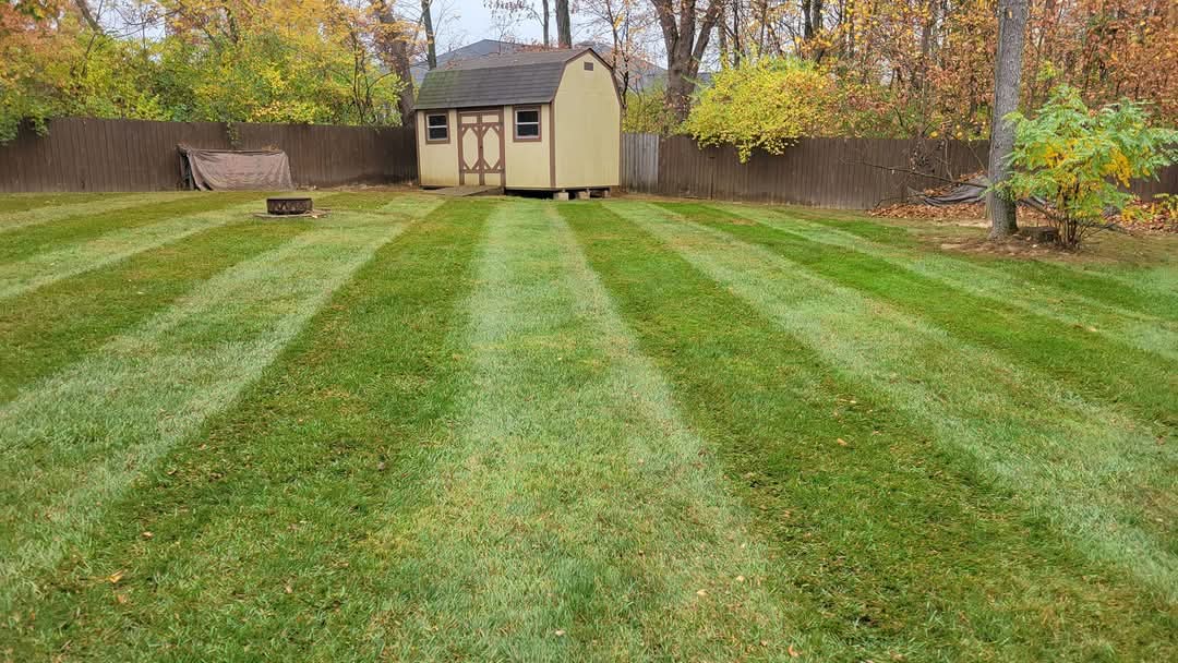 Professional striped residential lawn mowing service in Williamsburg, Ohio by Down to Earth