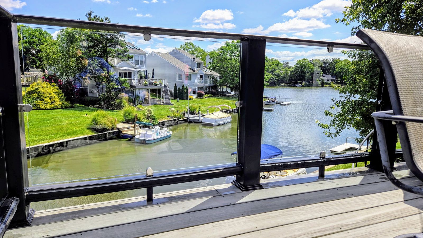 Crystal-clear lakefront view through freshly cleaned glass deck panels — window cleaning by Down to Earth in Greater Cincinnati
